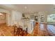 Spacious kitchen boasts modern white cabinets, large island, and terracotta tile floors at 2801 Hibiscus W Dr, Belleair Beach, FL 33786