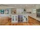 Island kitchen with wine cooler and terracotta tile floor at 2801 Hibiscus W Dr, Belleair Beach, FL 33786