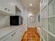 Bright laundry room with white cabinets, tile floor, and built-in storage at 2801 Hibiscus W Dr, Belleair Beach, FL 33786
