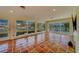 Spacious living room with wall-to-wall windows and water views at 2801 Hibiscus W Dr, Belleair Beach, FL 33786
