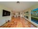 Living room features terracotta tile floors and large windows with water views at 2801 Hibiscus W Dr, Belleair Beach, FL 33786