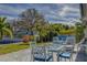 Outdoor patio with seating area, glass-top table, and beautiful water view at 2801 Hibiscus W Dr, Belleair Beach, FL 33786