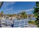 Relaxing patio overlooking the water with comfortable seating and a fire pit at 2801 Hibiscus W Dr, Belleair Beach, FL 33786