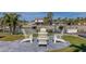 Waterfront patio with comfortable adirondack chairs, ideal for relaxing at 2801 Hibiscus W Dr, Belleair Beach, FL 33786