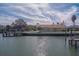 Waterfront home with private dock and lush landscaping at 2801 Hibiscus W Dr, Belleair Beach, FL 33786