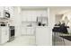 Modern white kitchen with stainless steel appliances and island at 35199 Gravelly Dr, Zephyrhills, FL 33541