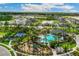 Aerial view of community with houses, lake, and resort-style amenities at 3637 Forest Path Dr, Plant City, FL 33565