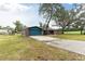 Brick ranch home with a blue garage door and red front door at 36441 Lake Pasadena Rd, Dade City, FL 33525