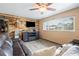 Living room with rustic wall decor and brown leather sectional at 36441 Lake Pasadena Rd, Dade City, FL 33525