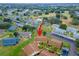 Aerial view of community, showing homes, landscape, and a pond at 401 Dorchester Pl # 52, Sun City Center, FL 33573