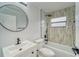 Modern bathroom with white vanity, bathtub, and walk-in shower at 401 Dorchester Pl # 52, Sun City Center, FL 33573