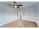 Bright bedroom with ceiling fan, wood-look floors, and ample closet space at 401 Dorchester Pl # 52, Sun City Center, FL 33573