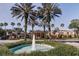 Community center with fountain and palm trees in front at 401 Dorchester Pl # 52, Sun City Center, FL 33573