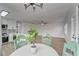 Charming dining area with a white table and four mint green chairs at 401 Dorchester Pl # 52, Sun City Center, FL 33573