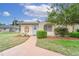 Condo exterior showcasing walkway, landscaping, and entryway at 401 Dorchester Pl # 52, Sun City Center, FL 33573