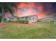 House exterior at sunset with lush landscaping at 401 Dorchester Pl # 52, Sun City Center, FL 33573