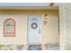 White front door with wreath, showcasing condo entry at 401 Dorchester Pl # 52, Sun City Center, FL 33573