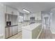 Modern kitchen with white cabinets, quartz countertops, and a peninsula at 401 Dorchester Pl # 52, Sun City Center, FL 33573