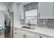Modern kitchen with stainless steel sink and white shaker cabinets at 401 Dorchester Pl # 52, Sun City Center, FL 33573