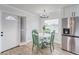 Bright kitchen features white shaker cabinets, quartz countertops, and stainless steel appliances at 401 Dorchester Pl # 52, Sun City Center, FL 33573