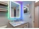 Modern bathroom with a marble-top vanity and LED mirror at 4611 W North B St # 129, Tampa, FL 33609