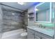 Updated bathroom with a tub, marble tile, and vanity at 4611 W North B St # 129, Tampa, FL 33609