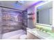 Bathroom featuring a tub, vanity, and LED lighting at 4611 W North B St # 129, Tampa, FL 33609