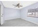 Bright bedroom with ceiling fan, window, and laminate flooring at 4611 W North B St # 129, Tampa, FL 33609