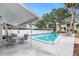 Inviting community pool with patio furniture and shade at 4611 W North B St # 129, Tampa, FL 33609