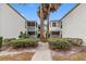 Back view of the Vineyard Condominium building, showing a courtyard and walkways at 4611 W North B St # 129, Tampa, FL 33609