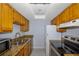 Kitchen with wood cabinets and granite countertops at 4611 W North B St # 129, Tampa, FL 33609