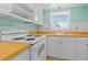 Kitchen boasts white cabinets and wood laminate floors at 5880 38Th N Ave # 305, St Petersburg, FL 33710