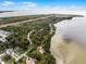 Aerial view highlighting waterfront access and natural surroundings at 605 Shore E Dr, Oldsmar, FL 34677