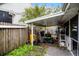 Covered patio area with gardening tools and lawnmower at 605 Shore E Dr, Oldsmar, FL 34677