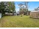 Large backyard with shed and spacious grassy area at 605 Shore E Dr, Oldsmar, FL 34677