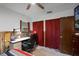 Bedroom with a workspace, closet, and red curtains at 605 Shore E Dr, Oldsmar, FL 34677