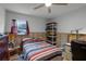 Bedroom with striped bedding, a workspace, and plenty of storage at 605 Shore E Dr, Oldsmar, FL 34677