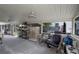 Enclosed patio with ceiling fans, seating, and birdcage at 605 Shore E Dr, Oldsmar, FL 34677
