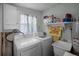 Laundry room with washer, dryer, utility sink, and shelving at 605 Shore E Dr, Oldsmar, FL 34677