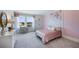 Charming bedroom with floral wall accent, vanity, and soft pink bedding at 6724 Broad River Ave, Land O Lakes, FL 34638