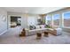 Bright bonus room features L-shaped sofa, bedroom access, and large windows at 6724 Broad River Ave, Land O Lakes, FL 34638