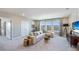 Spacious bonus room with L-shaped sofa, TV, and ample natural light at 6724 Broad River Ave, Land O Lakes, FL 34638