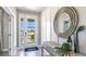 Bright and airy entryway with a large circular mirror and console table at 6724 Broad River Ave, Land O Lakes, FL 34638