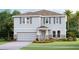 Two-story house with gray siding, stone accents, and a two-car garage at 6724 Broad River Ave, Land O Lakes, FL 34638