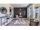 Home office with a dark-wood accent wall, desk, and comfortable seating at 6724 Broad River Ave, Land O Lakes, FL 34638