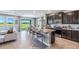 Open kitchen with granite countertops, dark cabinetry, and stainless steel appliances at 6724 Broad River Ave, Land O Lakes, FL 34638