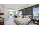 Large main bedroom with sitting area, water views, and dark green accent wall at 6724 Broad River Ave, Land O Lakes, FL 34638