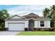 One-story home with a two-car garage and stone accents at 6732 Broad River Ave, Land O Lakes, FL 34638