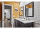 Updated bathroom features double sinks, stylish dark cabinets, and a mustard-colored wall at 705 Hidden Lake Dr, Brandon, FL 33511