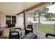 Relaxing back patio with seating area, overlooking a fenced backyard at 720 Sunset Dr, Tarpon Springs, FL 34689